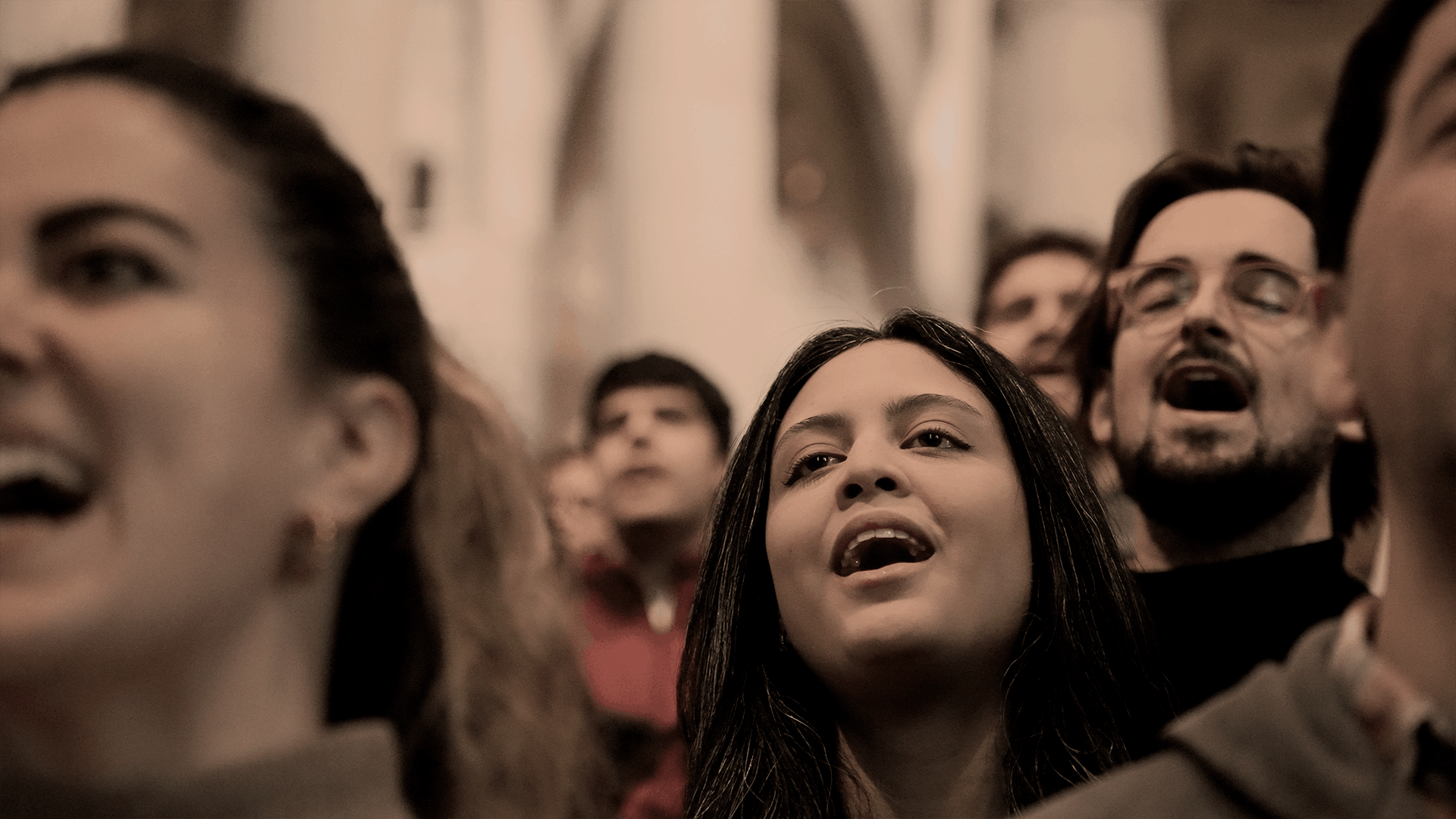 Black and white photo of a women performing modern dance on a dark background.